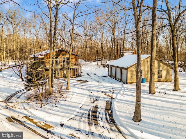 snowy yard with a garage