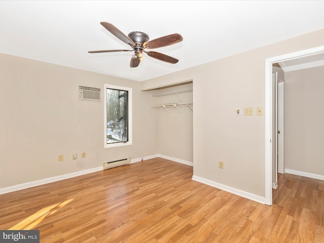 unfurnished bedroom featuring a wall mounted AC, baseboard heating, a closet, ceiling fan, and light hardwood / wood-style floors