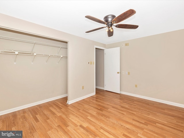 unfurnished bedroom featuring ceiling fan, light hardwood / wood-style floors, and a closet