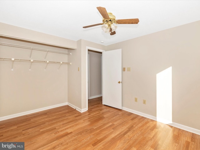 unfurnished bedroom featuring light hardwood / wood-style floors, a closet, and ceiling fan