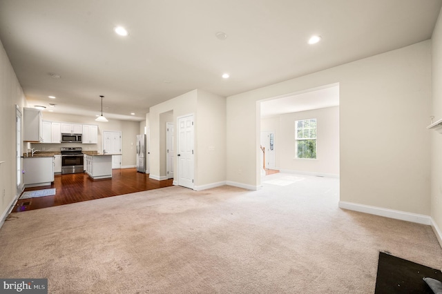 unfurnished living room with hardwood / wood-style flooring