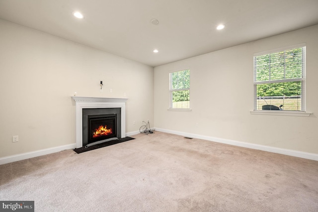 unfurnished living room with light colored carpet