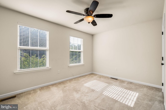 unfurnished room with ceiling fan and light colored carpet