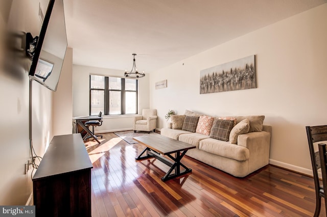 living room with wood-type flooring and an inviting chandelier