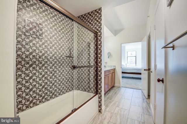 bathroom featuring vanity, lofted ceiling, and bath / shower combo with glass door