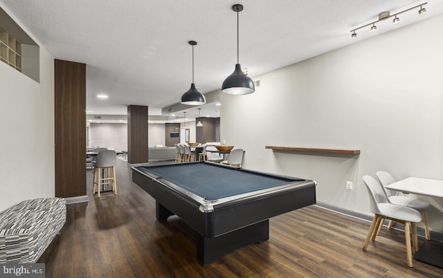 recreation room featuring billiards, a textured ceiling, and dark hardwood / wood-style flooring