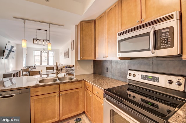 kitchen with sink, hanging light fixtures, stainless steel appliances, a notable chandelier, and light tile patterned floors