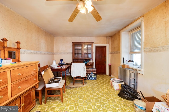 sitting room featuring ceiling fan