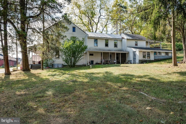 rear view of house with a yard