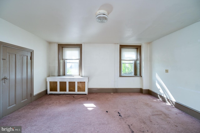 unfurnished bedroom featuring carpet floors and radiator heating unit