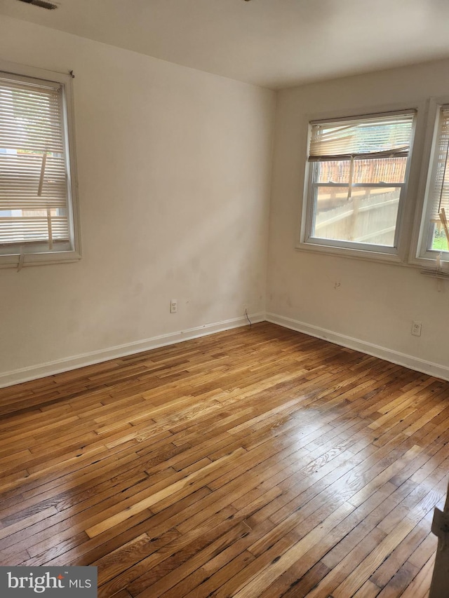 3839 1st St SE, Washington, DC 20032 - unfurnished room with hardwood / wood-style floors, baseboards, and a healthy amount of sunlight
