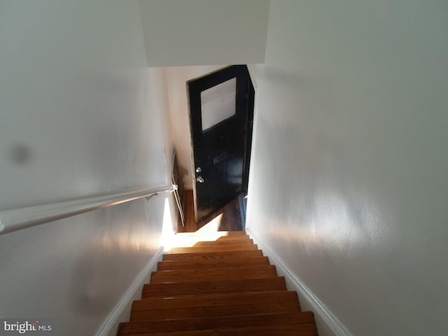 stairway featuring hardwood / wood-style floors