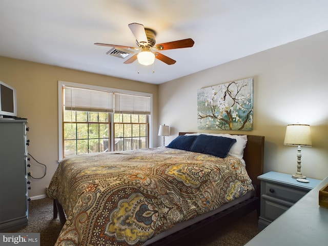 bedroom featuring dark carpet and ceiling fan