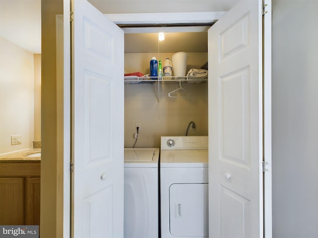 clothes washing area featuring independent washer and dryer