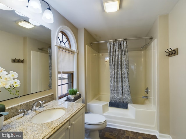 full bathroom featuring vanity, toilet, and shower / bath combination with curtain