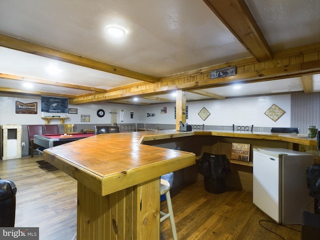 kitchen with beamed ceiling, white refrigerator, pool table, and hardwood / wood-style flooring