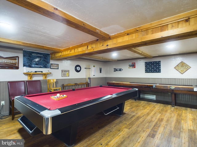 game room with hardwood / wood-style floors, beamed ceiling, and billiards