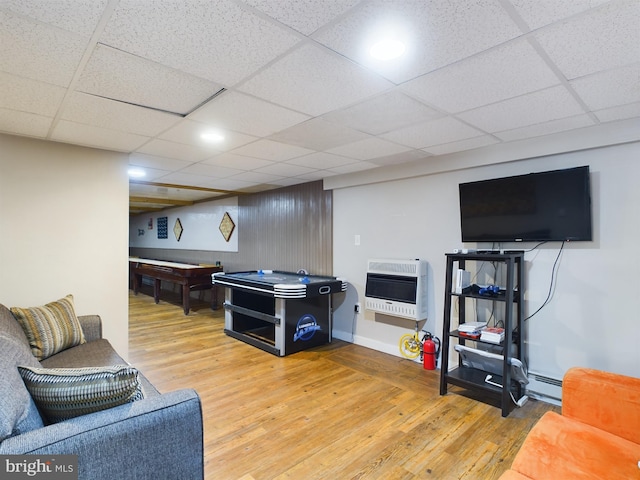 living room featuring a baseboard heating unit, a drop ceiling, hardwood / wood-style floors, and heating unit