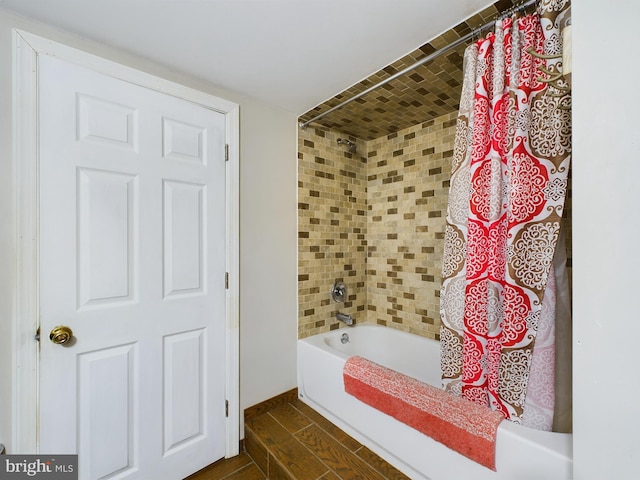 bathroom with shower / bath combo and hardwood / wood-style flooring