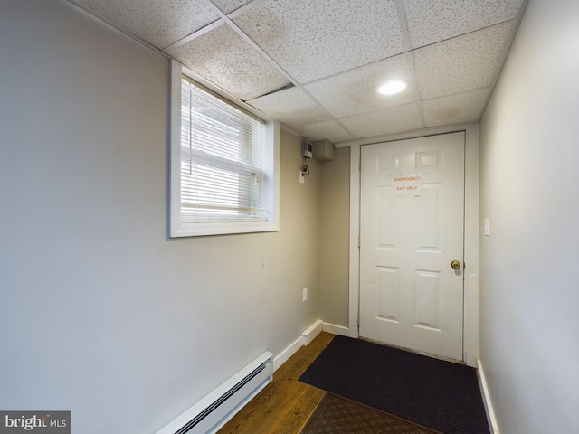 doorway featuring a drop ceiling and dark wood-type flooring