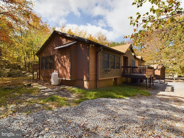 view of side of property with a wooden deck