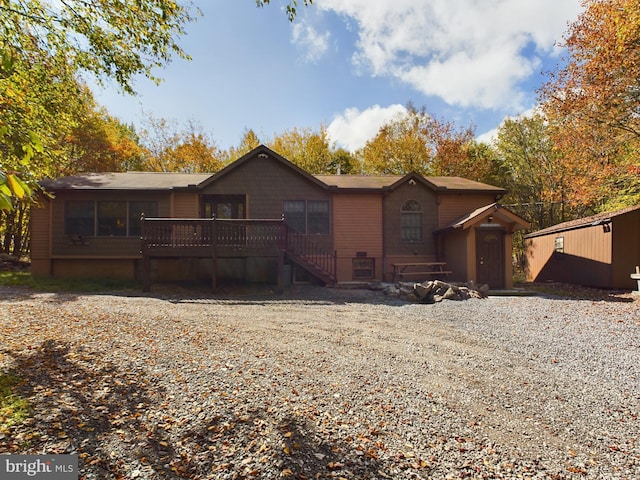 back of property with a wooden deck