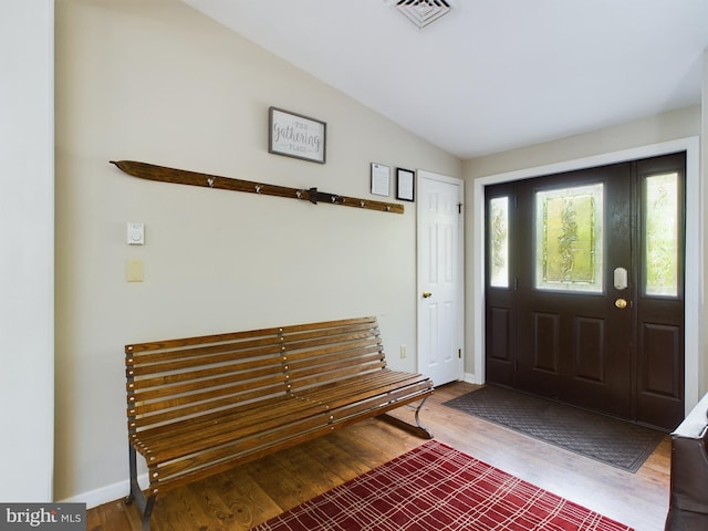 foyer with lofted ceiling and hardwood / wood-style floors