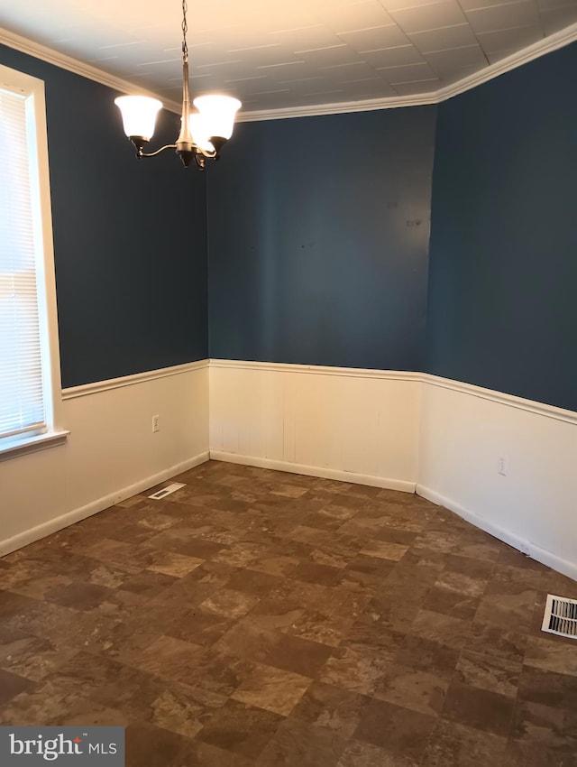 unfurnished room with crown molding and a notable chandelier