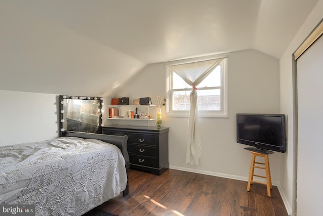 bedroom featuring dark wood-type flooring and vaulted ceiling