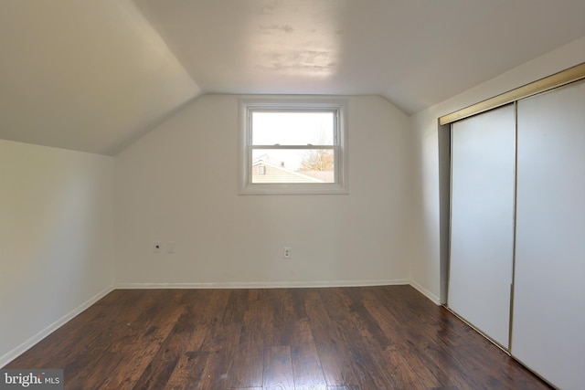 bonus room featuring lofted ceiling and dark hardwood / wood-style floors