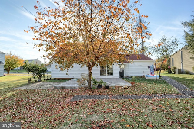 view of front of house with a patio and a front yard