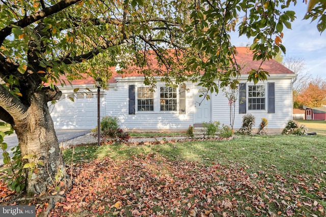 view of front facade with a front yard and a garage