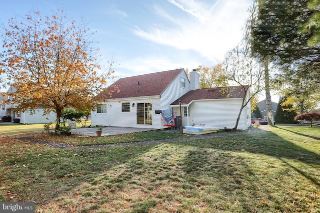 rear view of property with a patio area and a yard