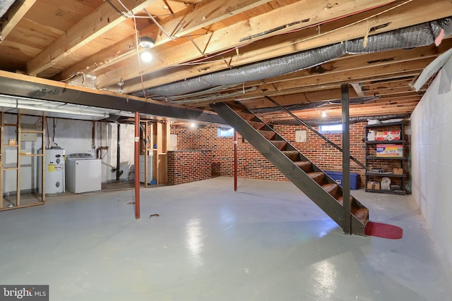 basement with water heater, washer / clothes dryer, and brick wall