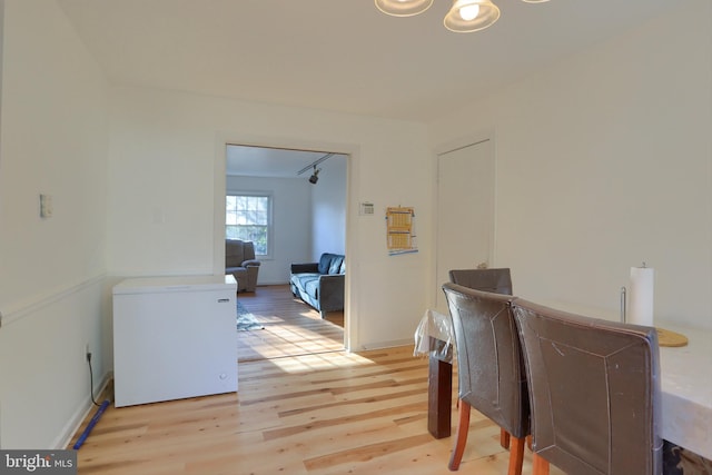 dining area featuring light wood-type flooring