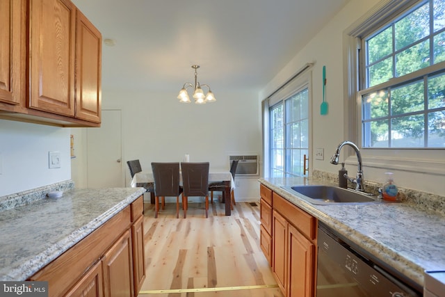 kitchen with dishwasher, sink, light hardwood / wood-style floors, and plenty of natural light