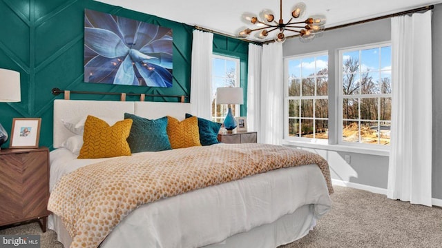 carpeted bedroom with a notable chandelier