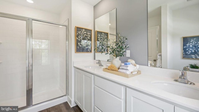 bathroom featuring a shower with door, vanity, and hardwood / wood-style floors