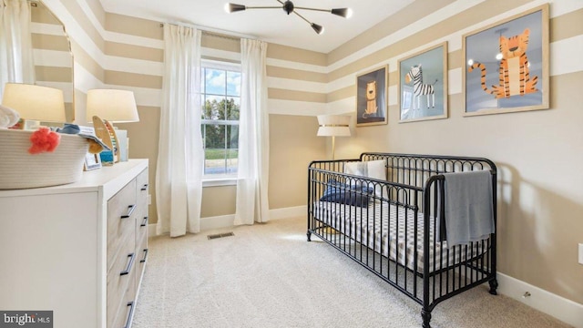 bedroom featuring light colored carpet and a crib