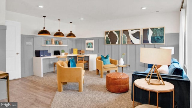 living room featuring built in desk and light wood-type flooring