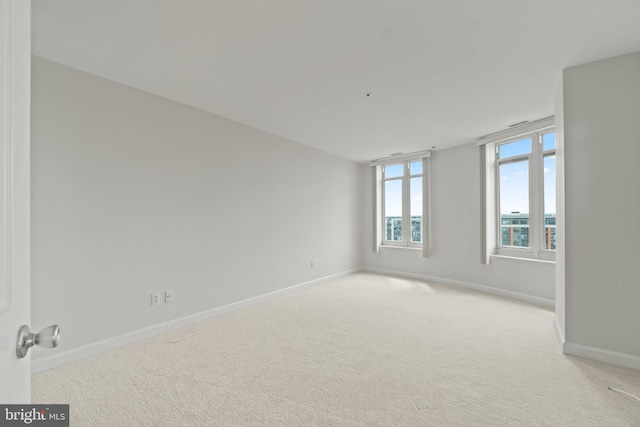 empty room featuring light carpet