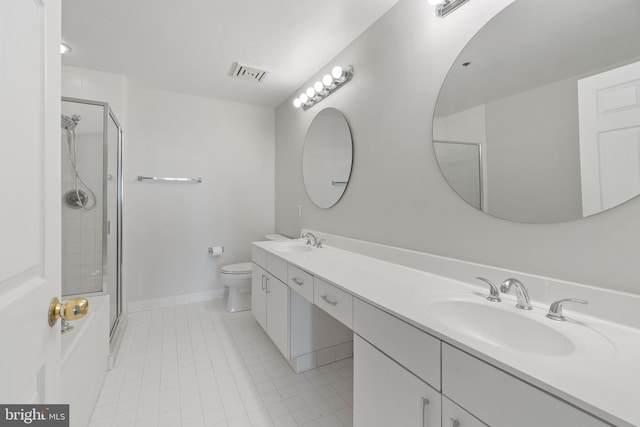 bathroom with vanity, toilet, a shower with door, and tile patterned floors