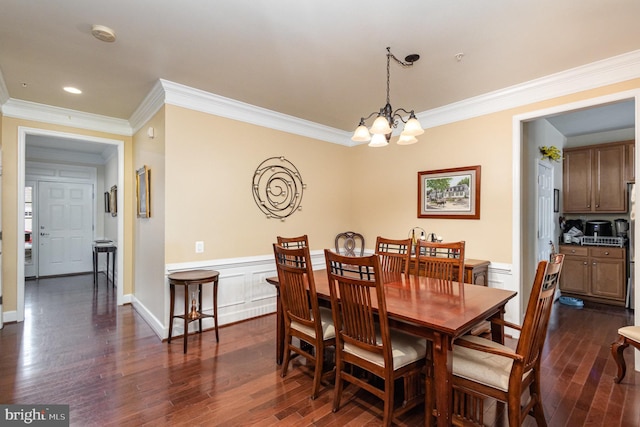 dining room with dark hardwood / wood-style flooring, crown molding, and a notable chandelier