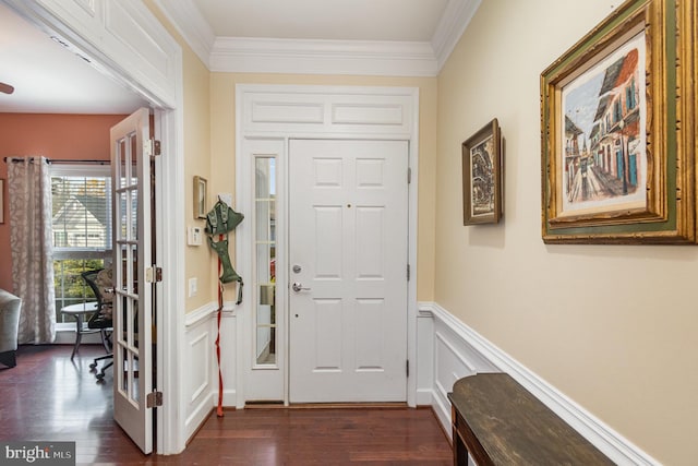 entryway with dark hardwood / wood-style flooring and crown molding