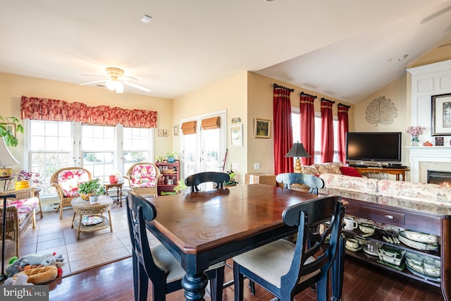 dining area featuring ceiling fan, vaulted ceiling, dark hardwood / wood-style floors, and plenty of natural light