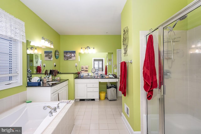 bathroom featuring tile patterned flooring, vanity, and separate shower and tub