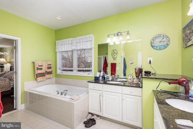 bathroom featuring independent shower and bath, vanity, and tile patterned floors