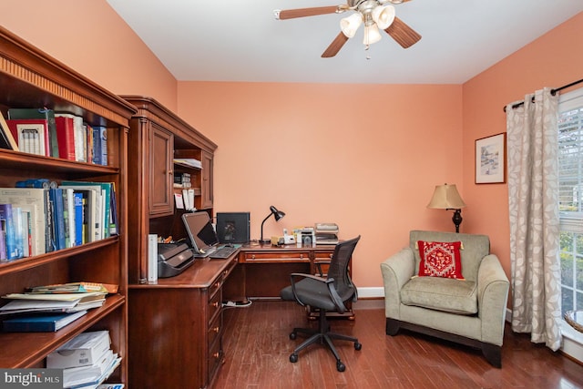 home office with dark hardwood / wood-style flooring and ceiling fan