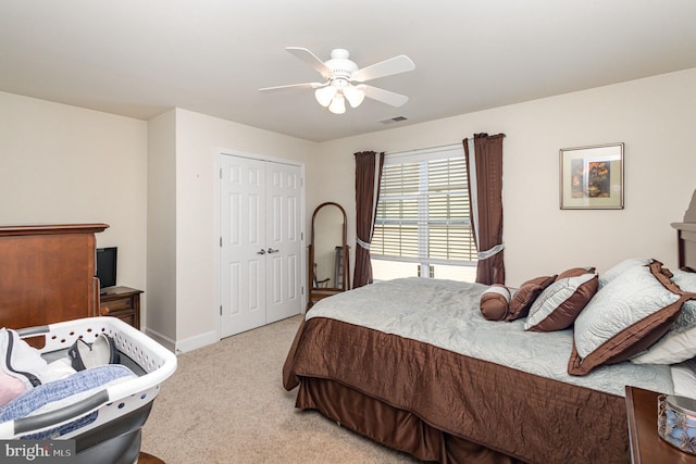 bedroom featuring a closet, light colored carpet, and ceiling fan