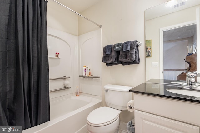 full bathroom with vanity, shower / bath combo with shower curtain, and toilet